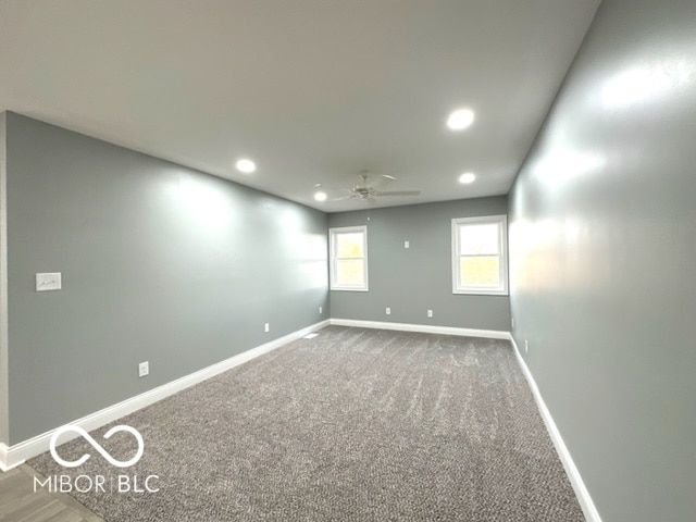 spare room featuring ceiling fan and carpet floors