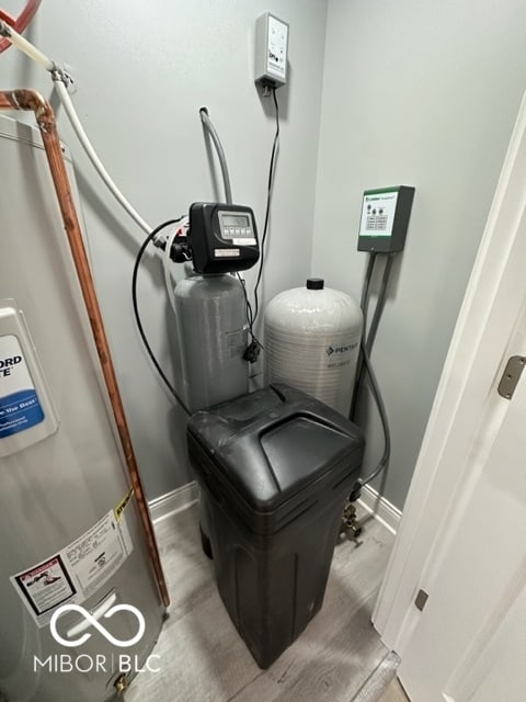 utility room featuring electric water heater