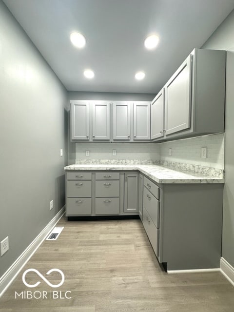 kitchen featuring gray cabinets and light wood-type flooring