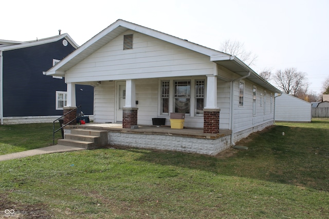 view of front of house featuring covered porch and a front lawn