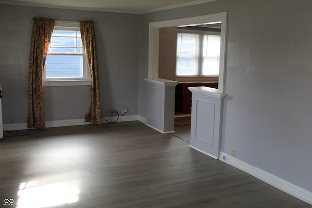 spare room with crown molding and dark hardwood / wood-style floors