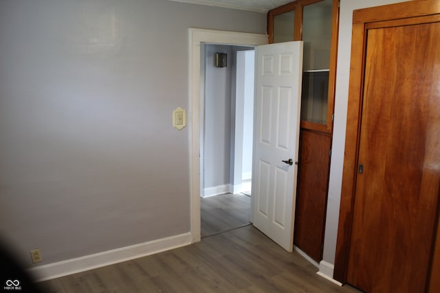 hallway with hardwood / wood-style floors