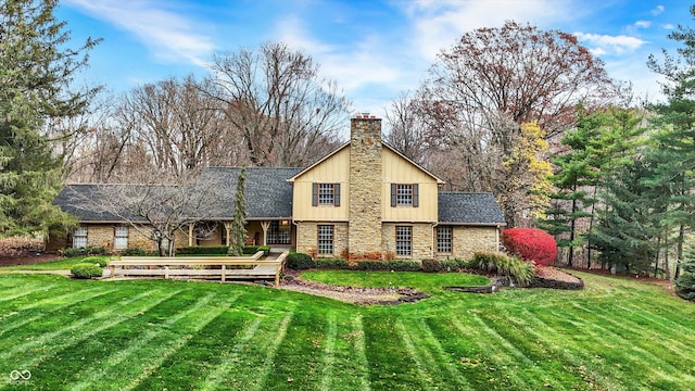 rear view of house featuring a yard