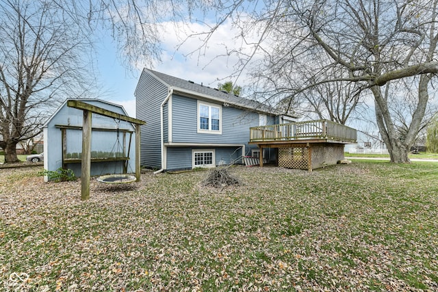 back of property featuring a shed, a deck, and a yard