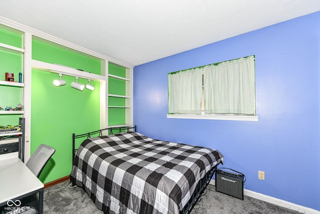 carpeted bedroom with a textured ceiling and track lighting