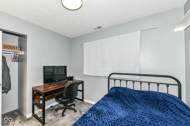 carpeted bedroom featuring a textured ceiling