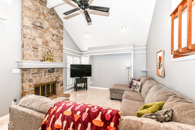 living room featuring high vaulted ceiling, a stone fireplace, ceiling fan, beam ceiling, and light hardwood / wood-style floors