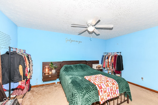 carpeted bedroom with a textured ceiling and ceiling fan