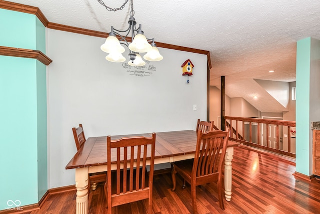 dining space featuring a chandelier, a textured ceiling, dark hardwood / wood-style flooring, and crown molding