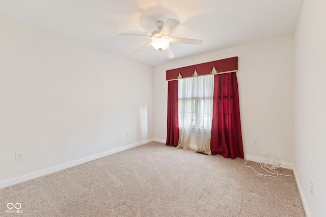 spare room with carpet floors and ceiling fan