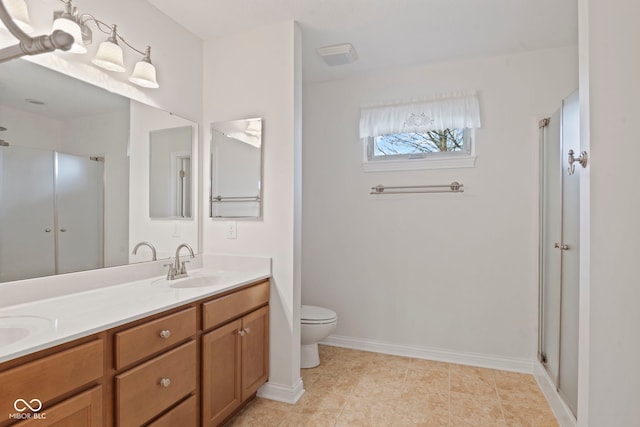 bathroom with toilet, vanity, and walk in shower