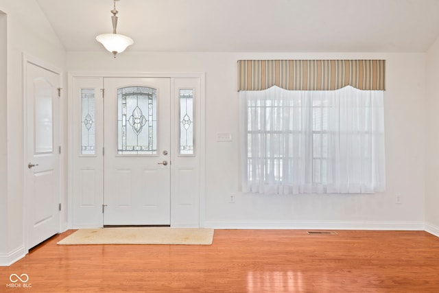 entryway with hardwood / wood-style floors and lofted ceiling