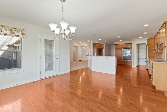 interior space with light wood-type flooring and an inviting chandelier