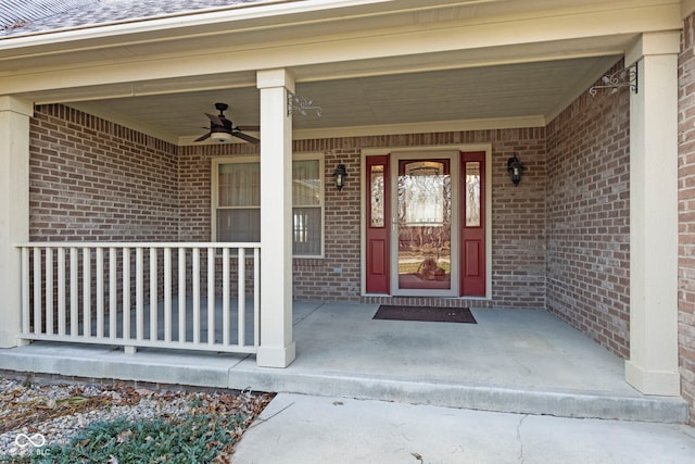 entrance to property with a porch and ceiling fan