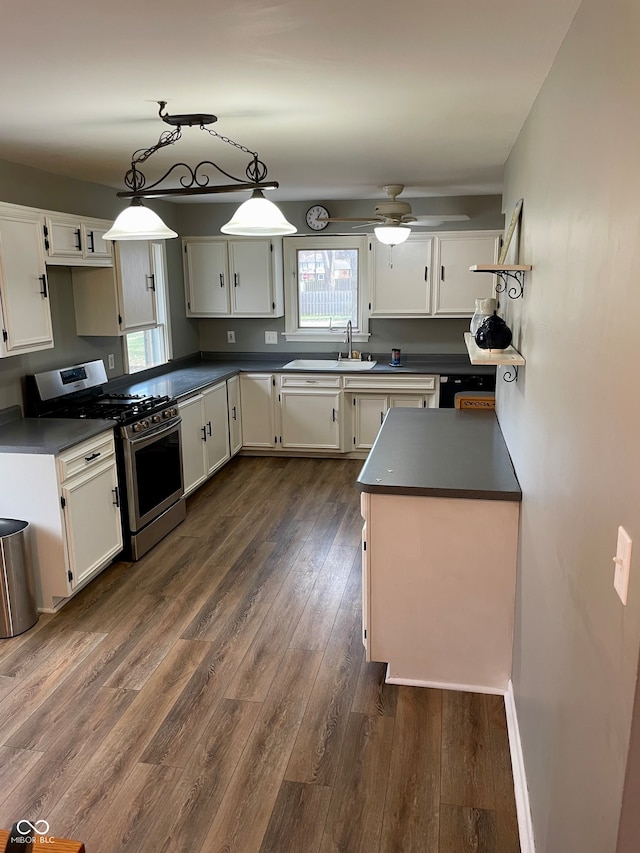 kitchen featuring white cabinets, a healthy amount of sunlight, dark hardwood / wood-style flooring, and stainless steel gas range