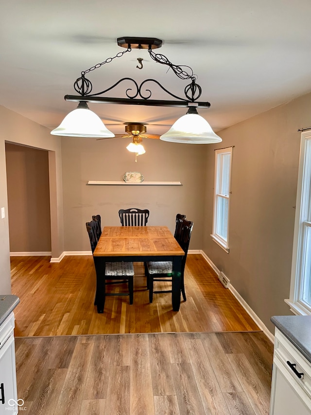 dining room with ceiling fan and light hardwood / wood-style floors