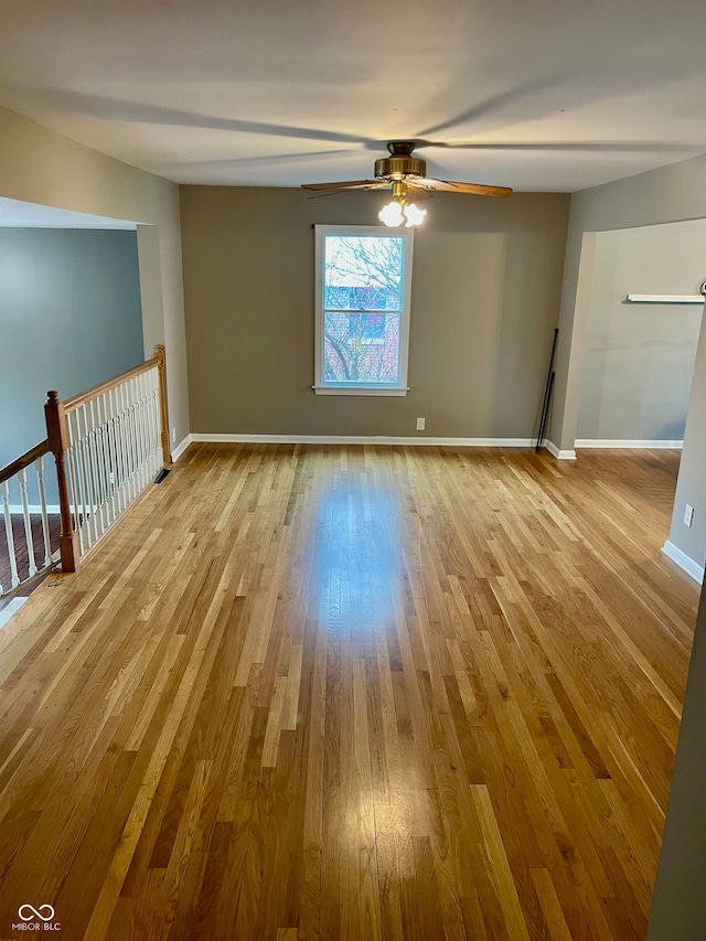 spare room featuring light hardwood / wood-style flooring and ceiling fan