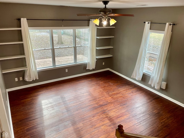 unfurnished dining area featuring ceiling fan and dark hardwood / wood-style floors