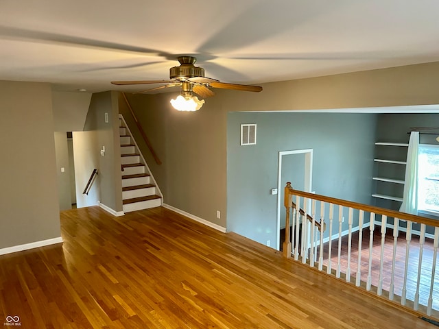 empty room featuring ceiling fan and wood-type flooring