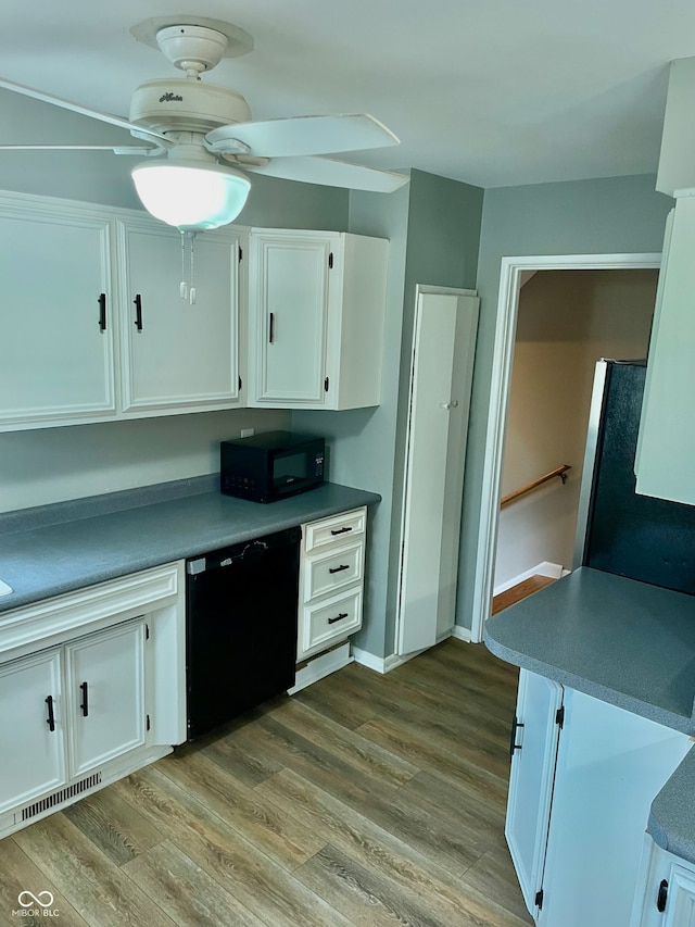 kitchen featuring black appliances, white cabinets, and light wood-type flooring