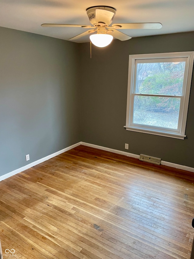 unfurnished room with ceiling fan and light hardwood / wood-style floors