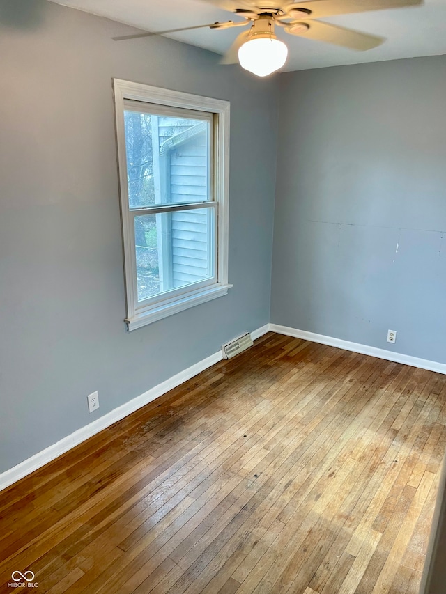 unfurnished room with ceiling fan and hardwood / wood-style flooring