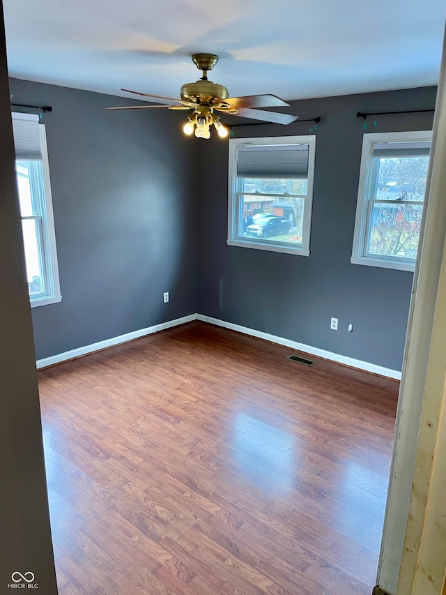 spare room featuring dark hardwood / wood-style floors and ceiling fan