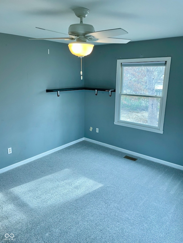 empty room featuring carpet and ceiling fan