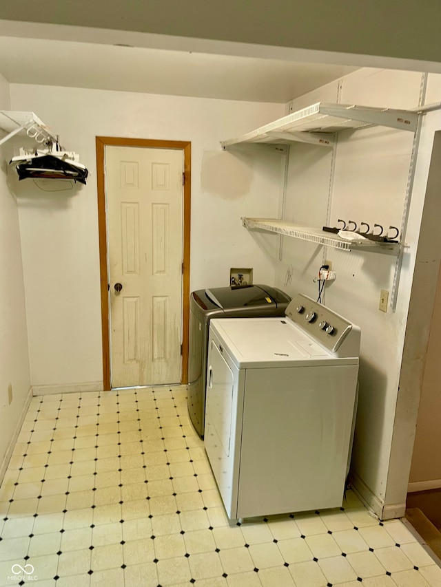 clothes washing area featuring washer and clothes dryer