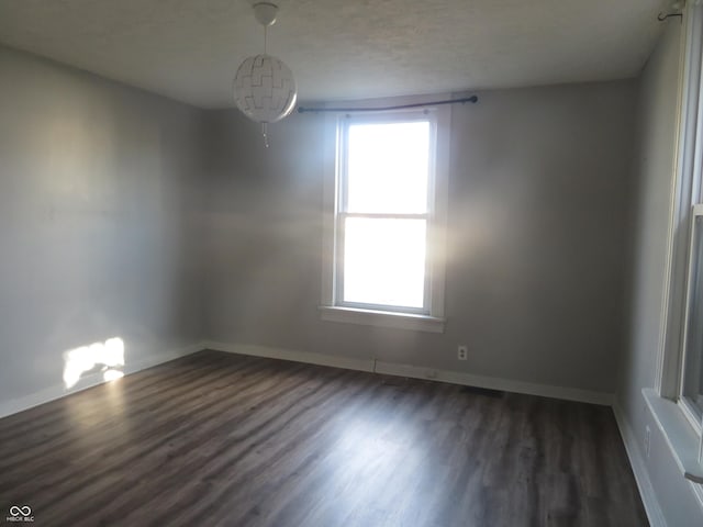 empty room with dark wood-type flooring