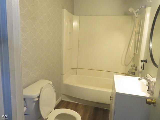 full bathroom with hardwood / wood-style floors, vanity, shower / bathtub combination, and toilet