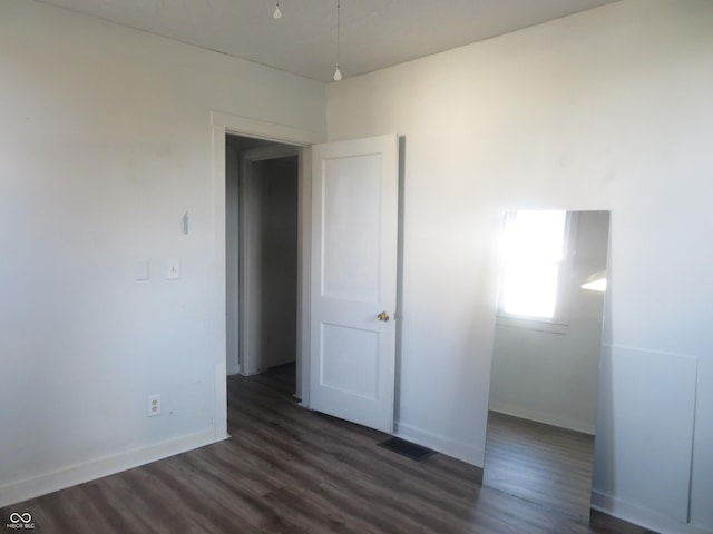 empty room with dark hardwood / wood-style floors