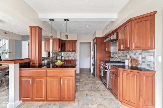 kitchen featuring kitchen peninsula, a textured ceiling, stainless steel appliances, and tasteful backsplash