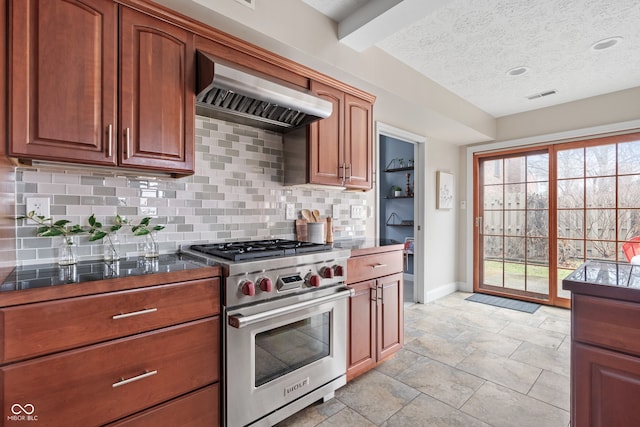 kitchen featuring decorative backsplash, a textured ceiling, premium range hood, and premium stove