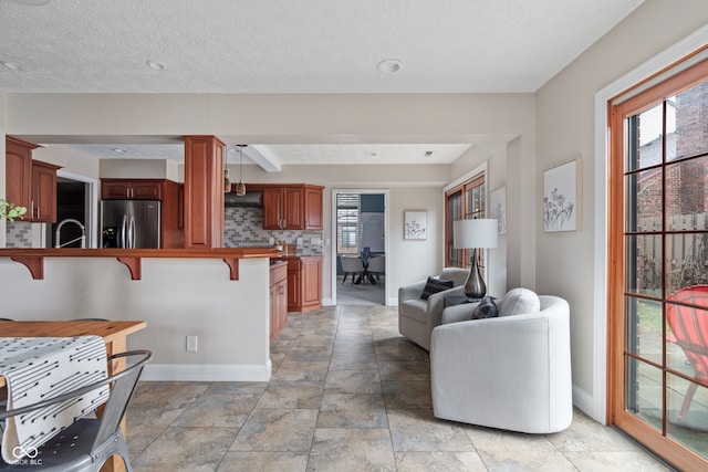 living room featuring a textured ceiling and sink