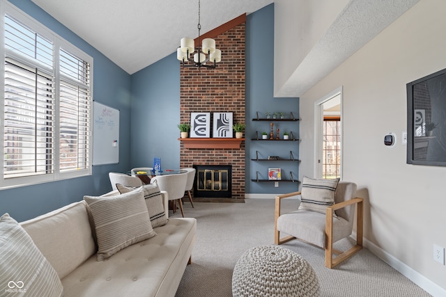 carpeted living room with a fireplace, a healthy amount of sunlight, a textured ceiling, and an inviting chandelier