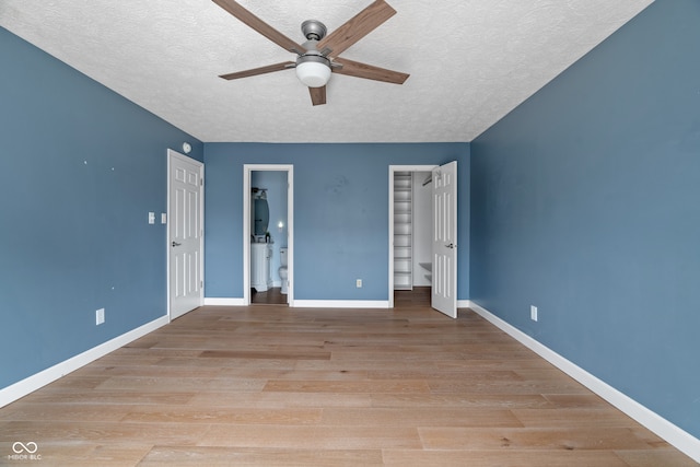 unfurnished bedroom featuring ceiling fan, light hardwood / wood-style flooring, and a textured ceiling