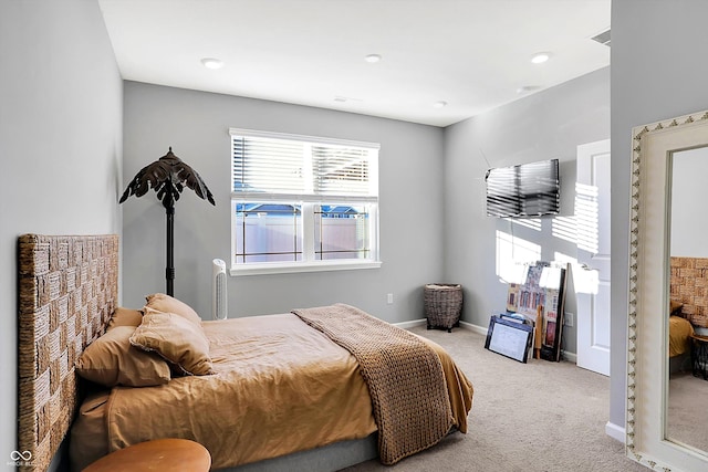 bedroom featuring light carpet