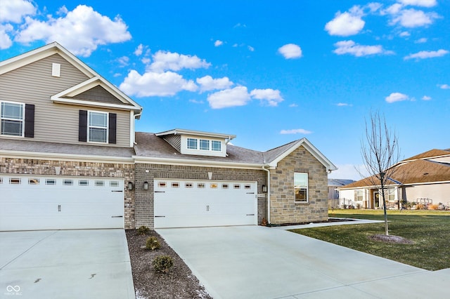 view of front of property with a front yard and a garage