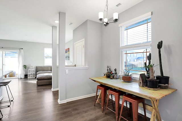 dining area featuring a chandelier and dark wood-type flooring