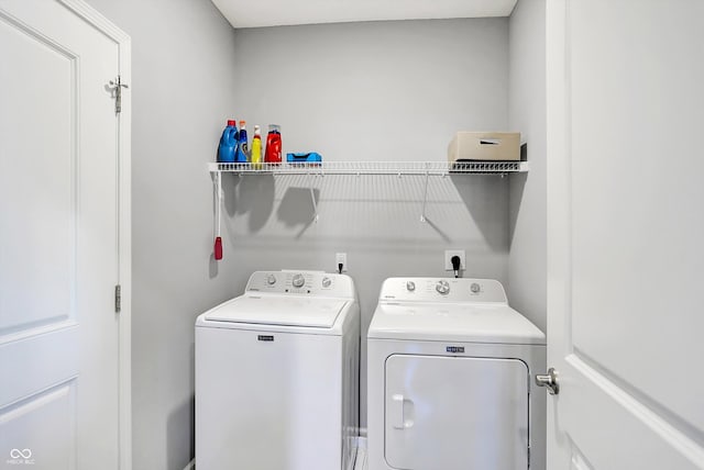 laundry area featuring washing machine and clothes dryer