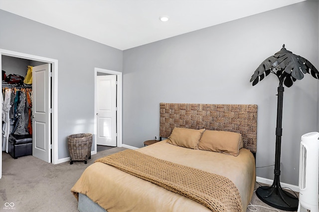 bedroom featuring light carpet and a closet