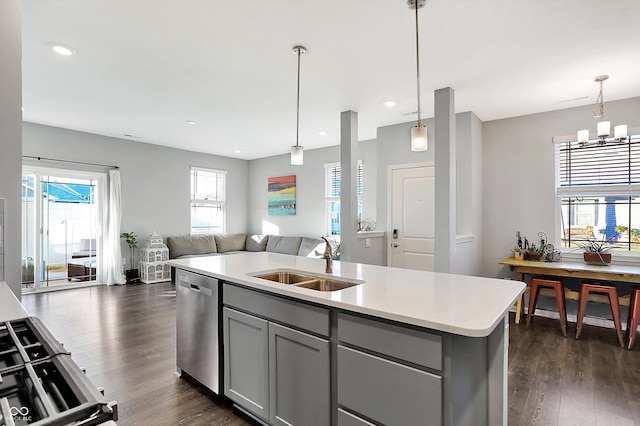 kitchen with dishwasher, a kitchen island with sink, plenty of natural light, and sink