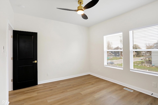 empty room featuring ceiling fan and light hardwood / wood-style flooring