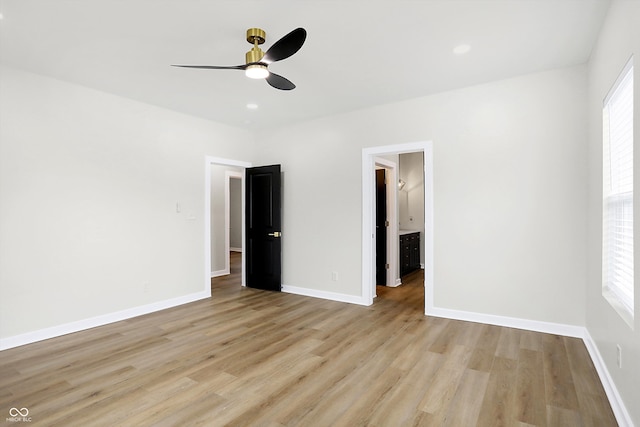 unfurnished bedroom featuring light wood-type flooring, multiple windows, and ceiling fan