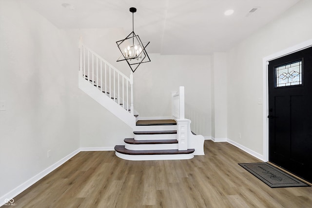 entrance foyer featuring wood-type flooring and a notable chandelier