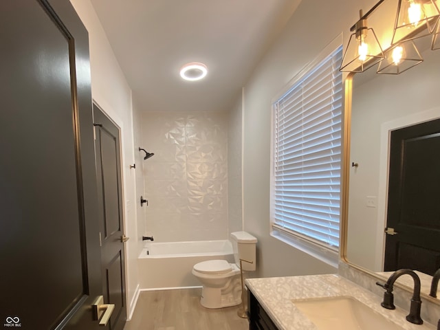 full bathroom featuring vanity, shower / bathing tub combination, a notable chandelier, hardwood / wood-style floors, and toilet