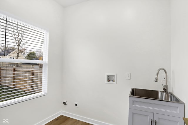 washroom with cabinets, dark hardwood / wood-style flooring, plenty of natural light, and sink