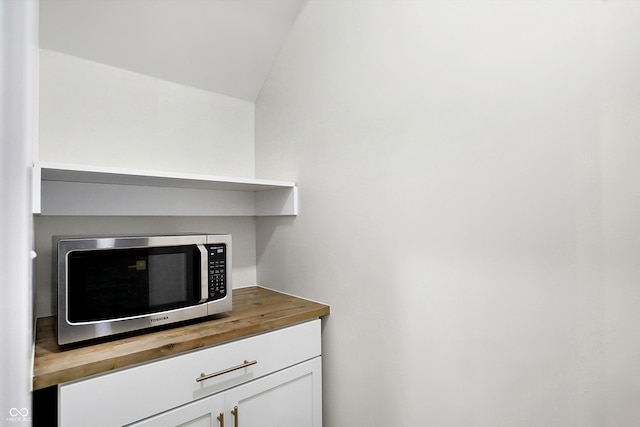 details with butcher block counters and white cabinets