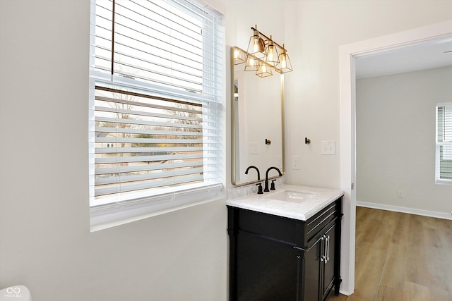 bathroom with vanity, wood-type flooring, and a chandelier